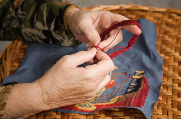 hands doing embroidery